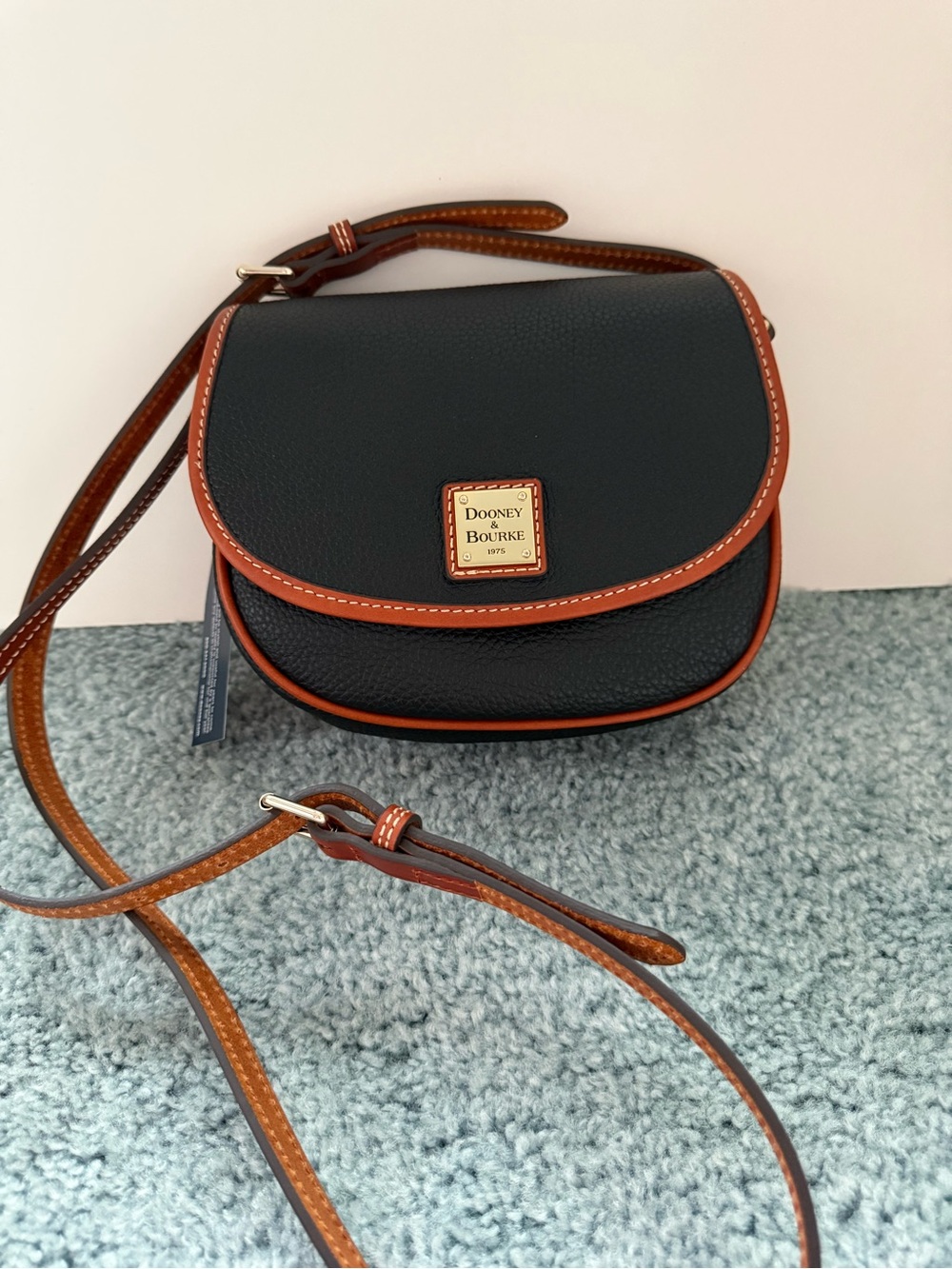 Dooney & Bourke Black Pebble Leather Crossbody with Brown Trim and Logo Plaque